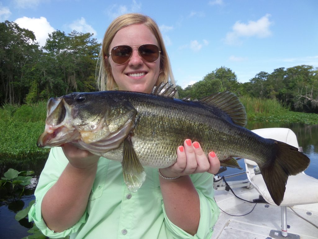 Woman in Sunglasses Holding Fish