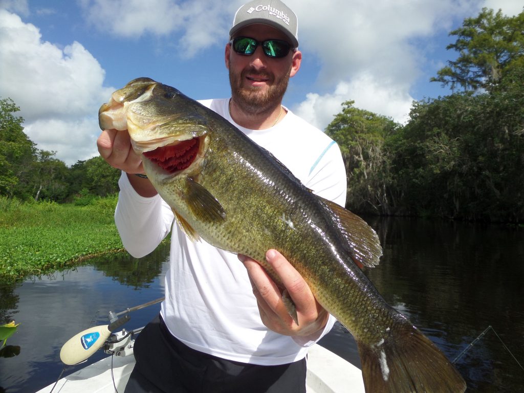 Man on boat Holding Fish
