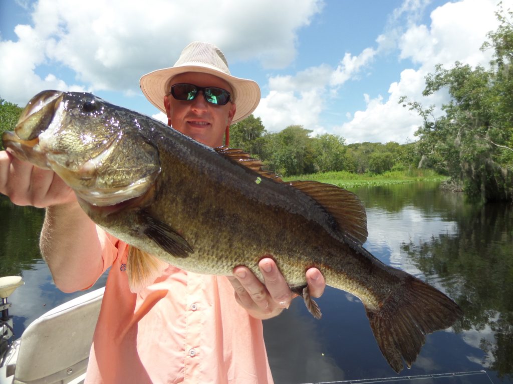 Man on lake holding fish