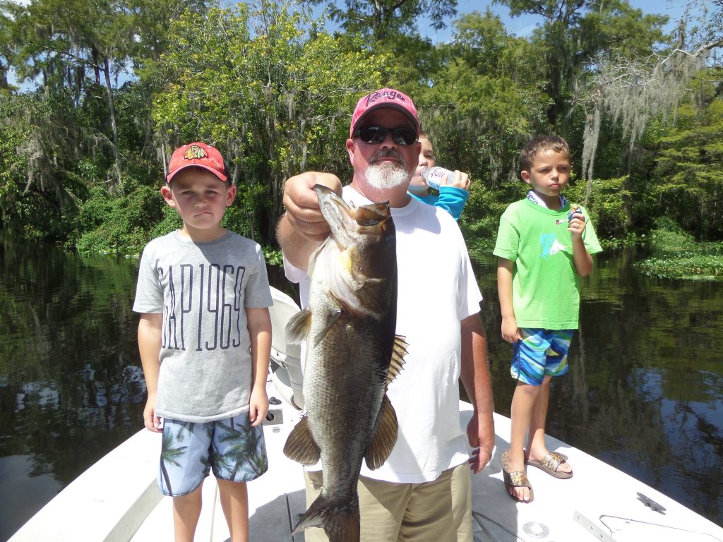 Man holding fish with kids