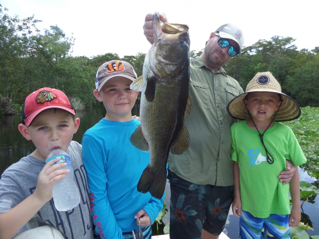 Man with kids holding fish